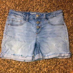 Hippie girl jean denim shorts with distressed cuffs.
